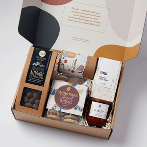 Australian Christmas hamper with artisan treats, Indigenous tea, handmade nougat, soy candle, and festive chocolates - a thoughtful ethical gift supporting local makers.