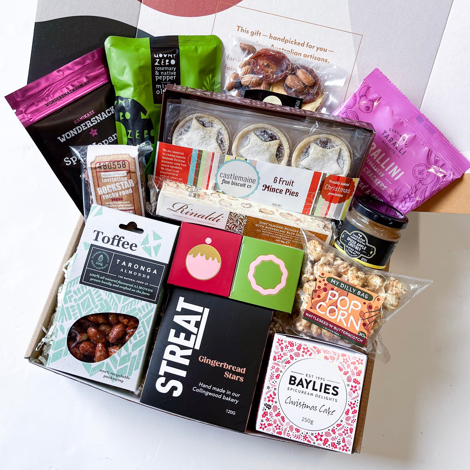 Handcrafted gourmet Australian goodies in an impressive Christmas hamper. Includes STREAT gingerbread stars, wattleseed popcorn, caramel chocolates, traditional fruit cake, plum pudding chocolates, SA fruit & nut mix, seasoned olives, fruit mince pies, pa