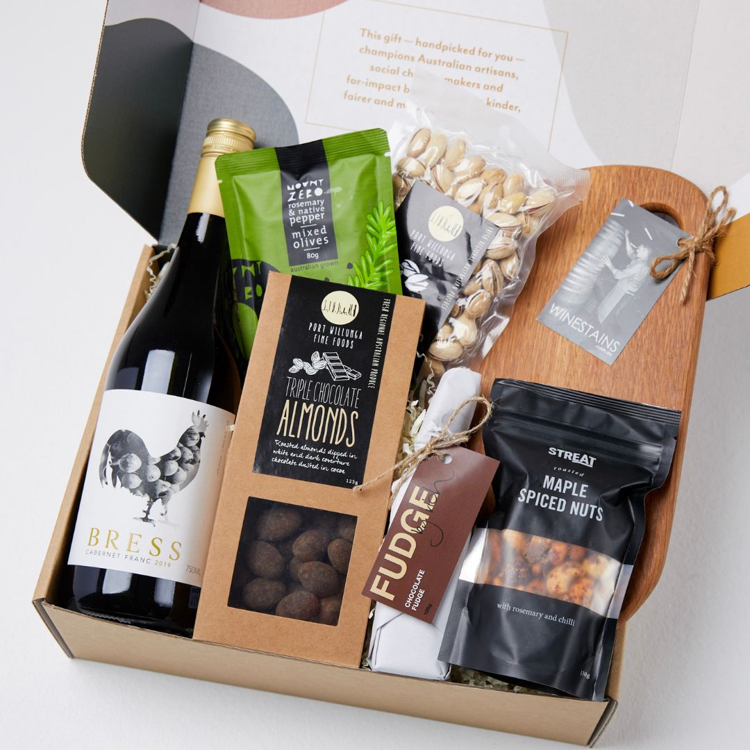 The foodie’s favorite gift hamper with wine, artisanal grazing board, almonds, pistachios, organic olives, fudge