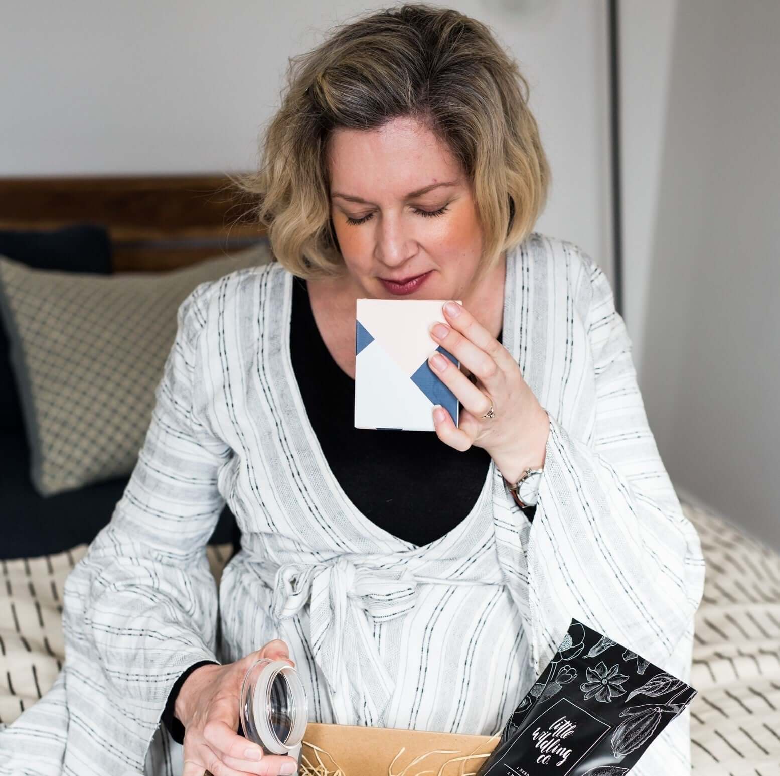 A curated selection of ethically sourced Mother’s Day gifts beautifully arranged in sustainable packaging, including artisan chocolates, natural bath products, eco-friendly nail polish, and handcrafted teas, all celebrating self-care and social impact.