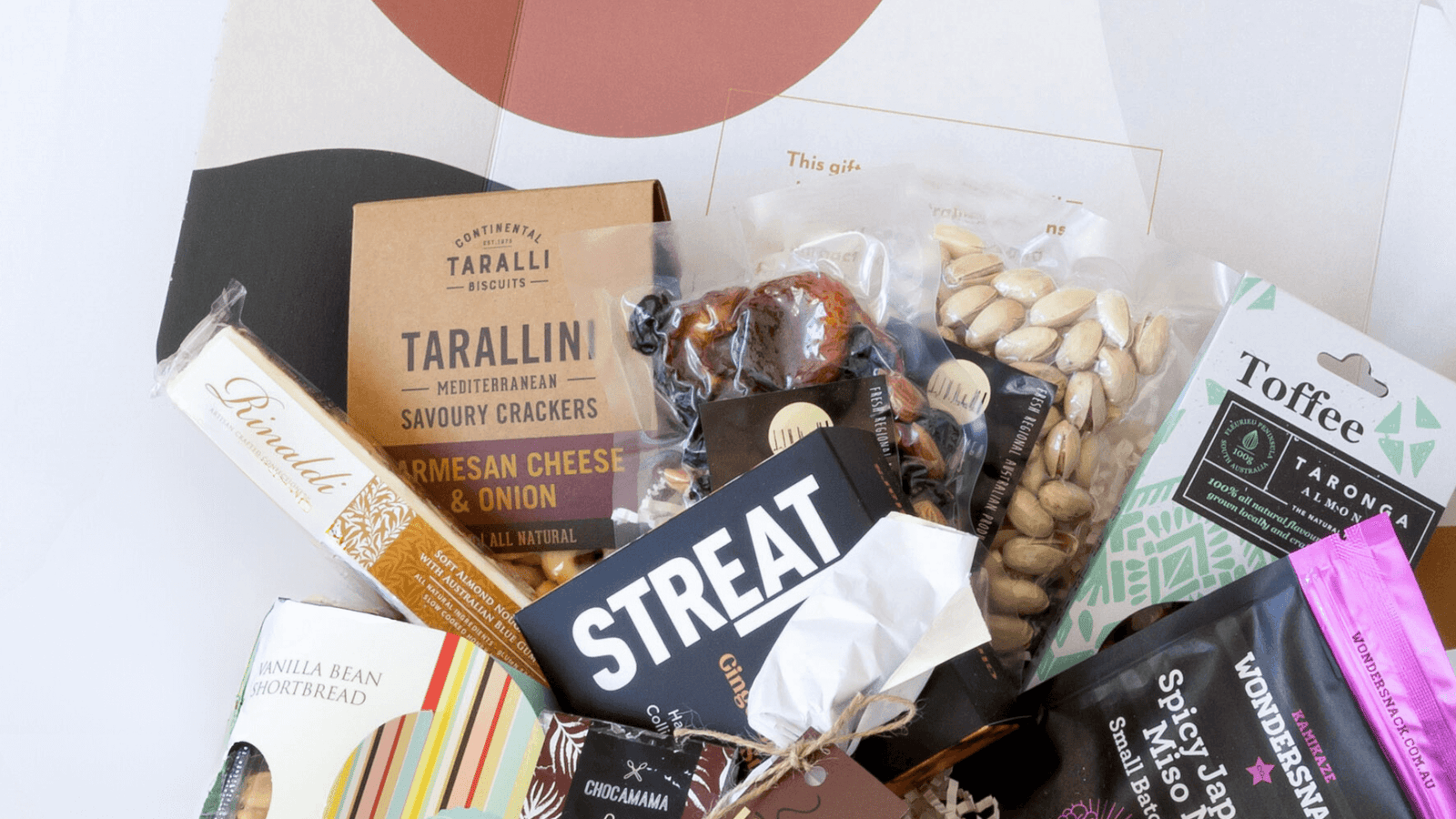 beautifully packed gourmet hamper featuring artisan snacks, crackers, toffee, nuts, and chocolate from Curated with Conscience, thoughtfully crafted gift hampers available in melbourne and across australia
