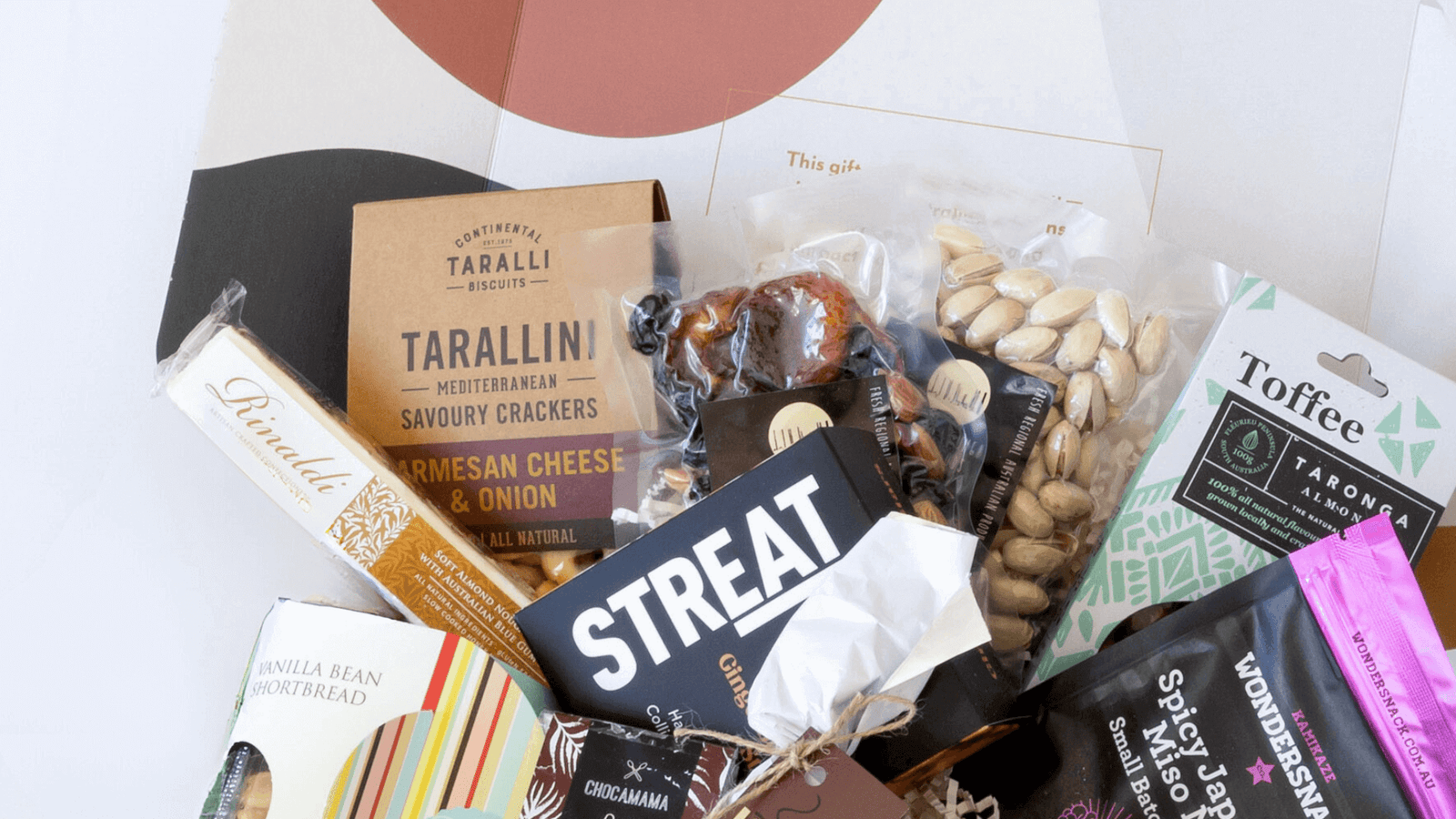 beautifully packed gourmet hamper featuring artisan snacks, crackers, toffee, nuts, and chocolate from Curated with Conscience, thoughtfully crafted gift hampers available in melbourne and across australia