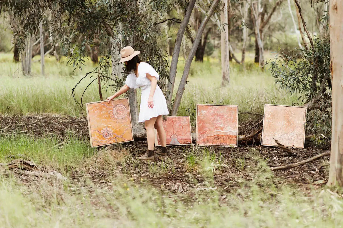 Amanda Hinkelmann, founder of Because of My Four, creates storytelling art inspired by culture, family, and connection to Country.