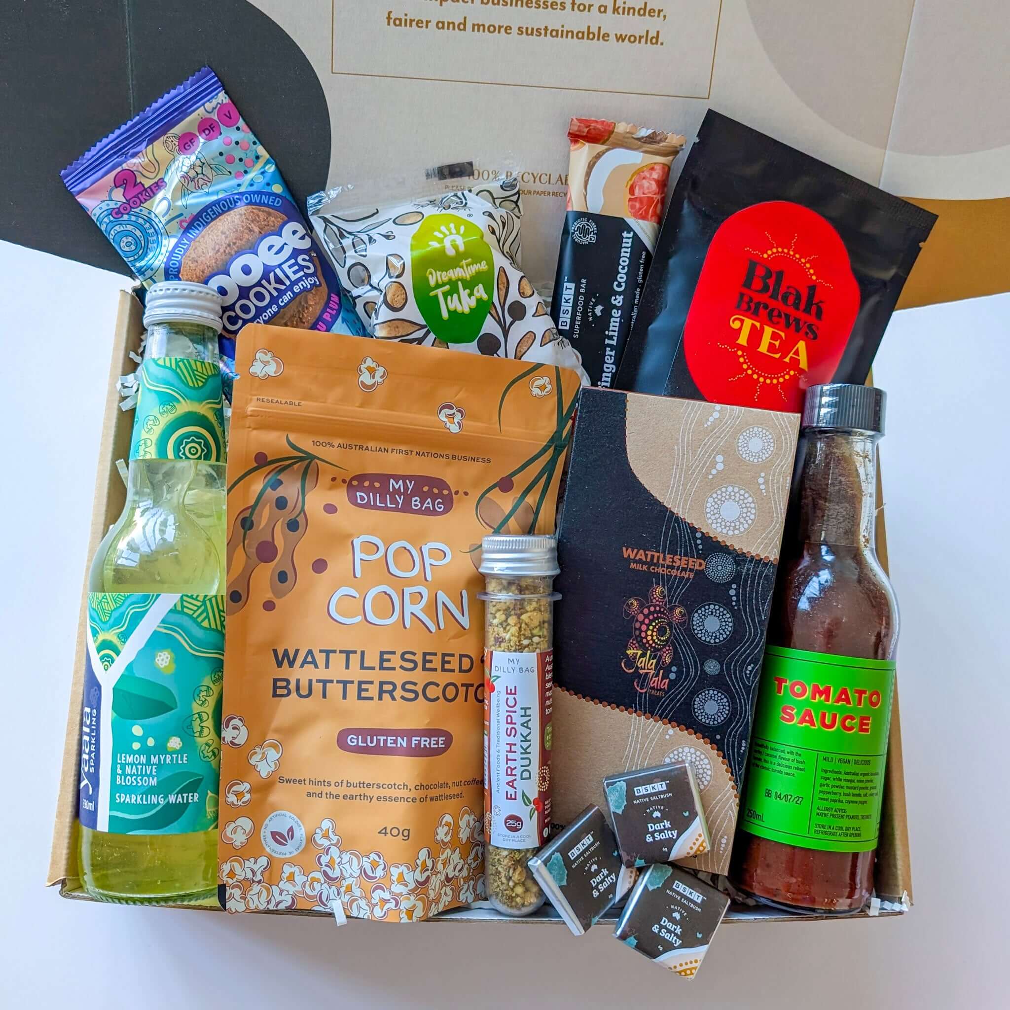 gourmet hamper from curated with conscience featuring artisan popcorn, cookies, tea, sauce, chocolate, and premium snacks thoughtfully presented for christmas hampers or employee giveaways for corporate hampers