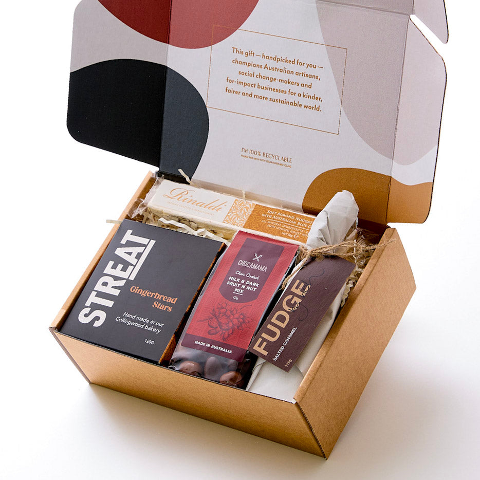 Artisan Christmas hamper with spiced gingerbread stars, salted caramel fudge, almond nougat, and chocolate-coated fruit and nuts