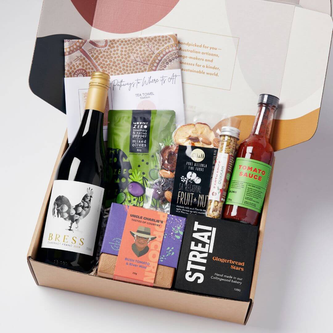 Australian summer hamper with artisan gourmet treats, Indigenous-owned products, organic cotton art tea towel, wine, and local delicacies. A perfect ethical gift for summer celebrations.