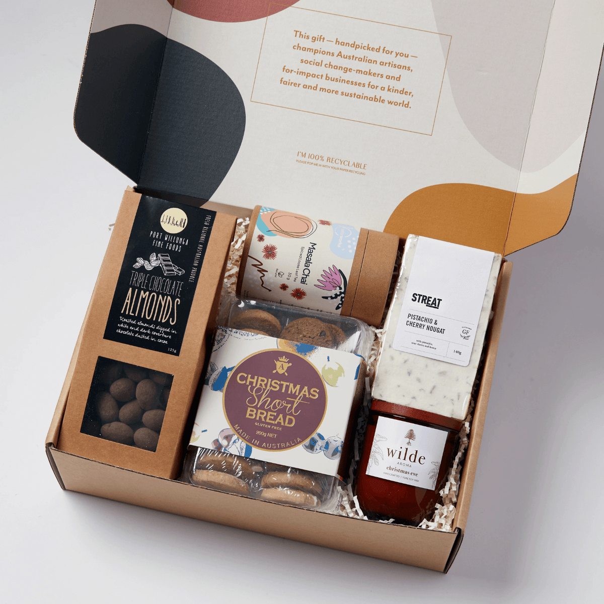 Australian Christmas hamper with artisan treats, Indigenous tea, handmade nougat, soy candle, and festive chocolates - a thoughtful ethical gift supporting local makers.