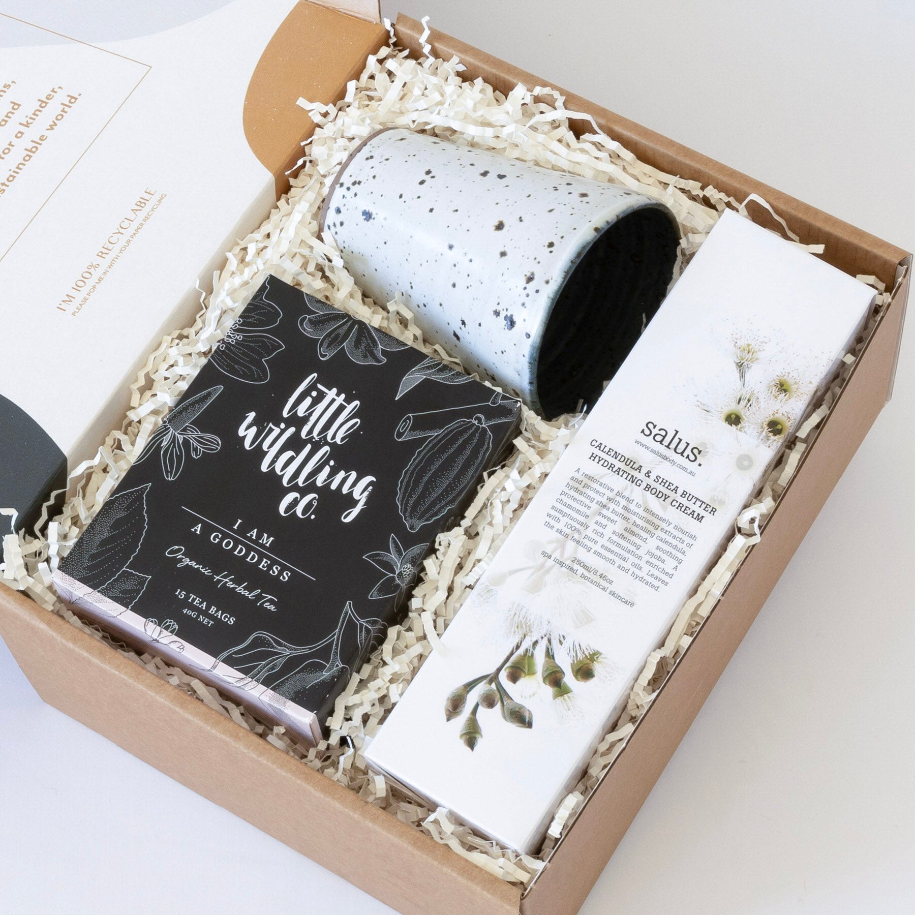 Goddess gift hamper with artisan ceramic cup, organic herbal tea, and natural hydrating body cream.