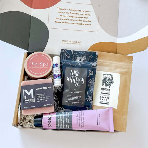Gift Hamper for women with products such as organic hand cream, lip balm, hand cream, soy candle, bath soak and clay soap and an organic tea which promotes womens heath in a beautiful box perfect as a gift from curated with conscience