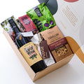 A hamper with charity-supporting Goodwill Wine, seasoned olives, recycled wine barrel wine charms, Mediterranean biscuits, salted caramel fudge, chocolate-coated fruit and nuts, and roasted macadamia. Handcrafted Australian artisan gifts.
