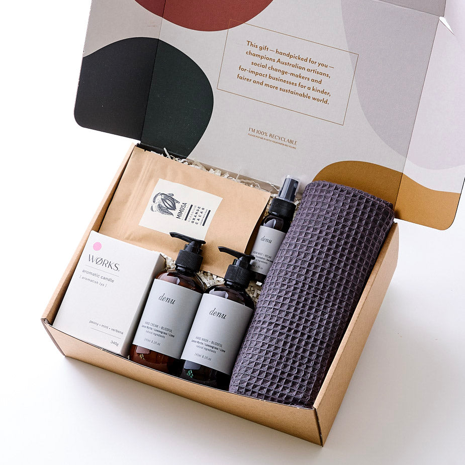 Gift hamper featuring natural hand wash, hand cream, room mist, soy wax candle, bath soak, and organic cotton hand towel. All sustainably made and beautifully packaged for a thoughtful housewarming present.