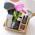 Australian gourmet hamper with artisanal treats including gingerbread stars, jams, nuts, crackers, olives, and chocolates. Sustainable and climate-friendly.