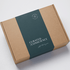 Cardboard box with a green label featuring 'Curated Conscience' hampers on a light gray background