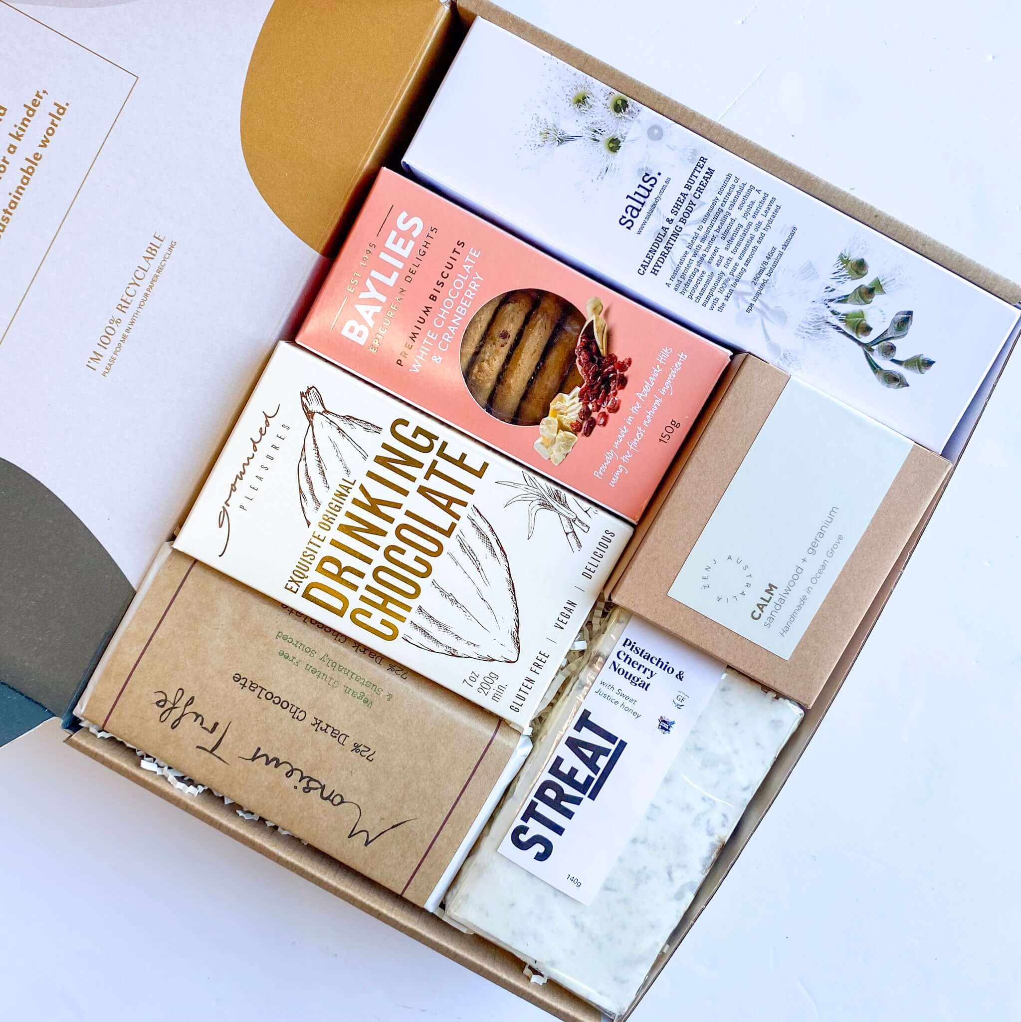 A gourmet hamper from Curated with Conscience featuring artisan cookies premium drinking chocolate, handmade treats, and soothing tea beautifully presented and perfect as a comforting present to uplift someone’s day