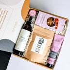 Self-care gift hamper with relaxing treats, perfect for colleagues, new mums, or for yourself. It includes essential oils, body mist, hand cream, lip balm and Baylies vanilla fig and caramel biscuits.