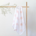Mama Maya Salmon Spot Swaddle hanging on a white background