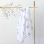 Mama Maya Grey Spot Swaddle hanging on a white background